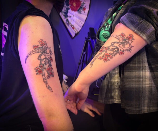 Couples matching arm scythe tattoo